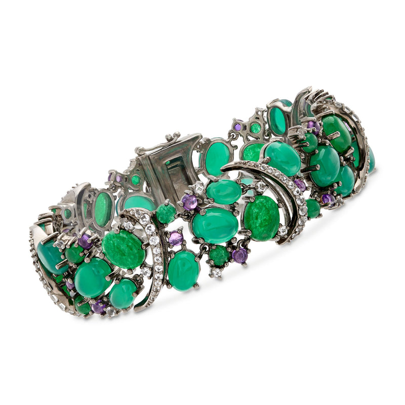 Sterling silver bracelet with green oval and round gemstones, purple accents, and prong settings