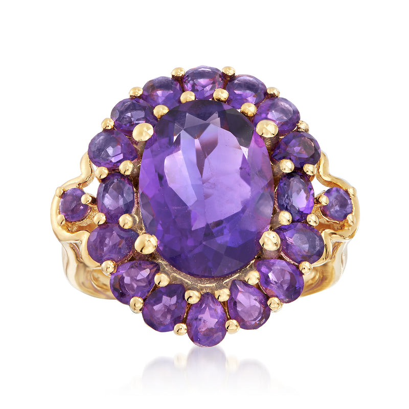 Amethyst ring with oval purple center stone and round side stones, yellow gold setting