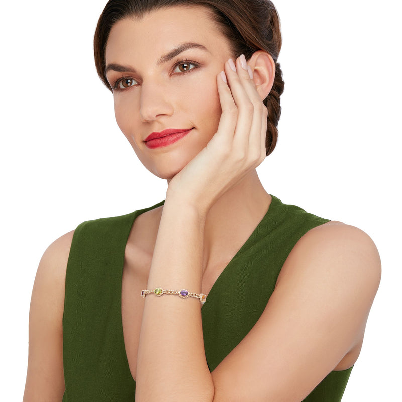 Gold multicolor gemstone curb-link bracelet worn on wrist