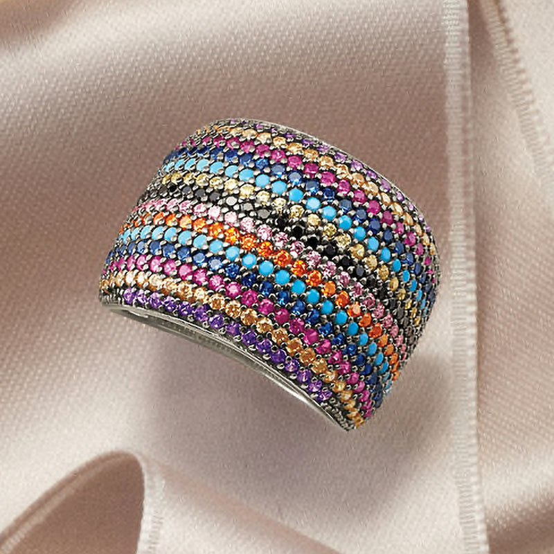 Multicolored CZ ring close-up on sterling silver, curved band with rainbow stone stripes