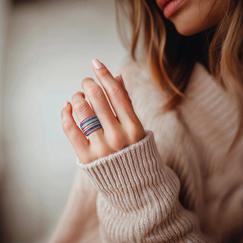 Multicolored CZ ring on finger, rainbow stone rows in sterling silver band