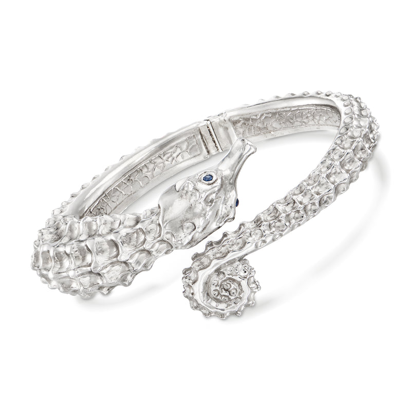 Sterling silver seahorse bypass bangle with sapphire accents, textured oval frame