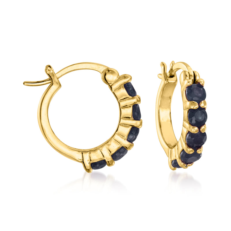 Gold-tone huggie hoop earrings with round dark blue gemstone accents