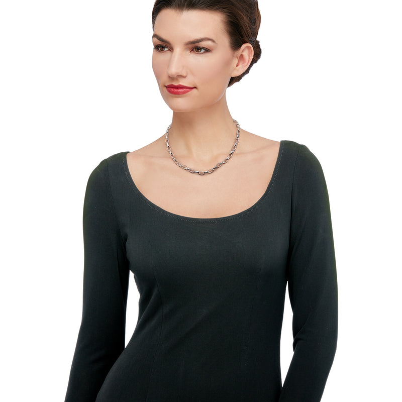 Sterling silver oval-link necklace worn on neckline with dark long-sleeve dress