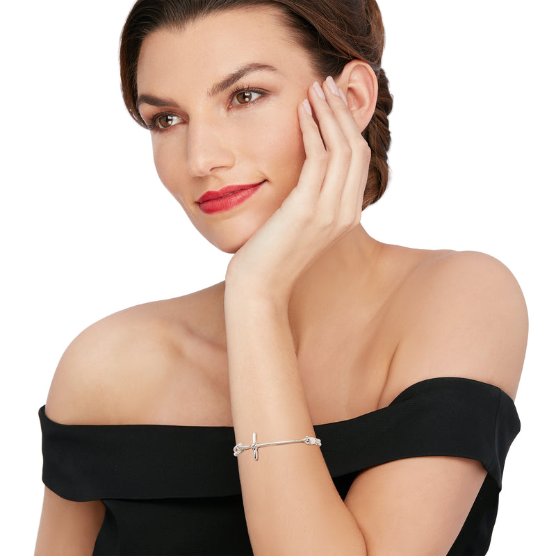 Zina sterling silver sideways cross bracelet on wrist, polished bar and clasp