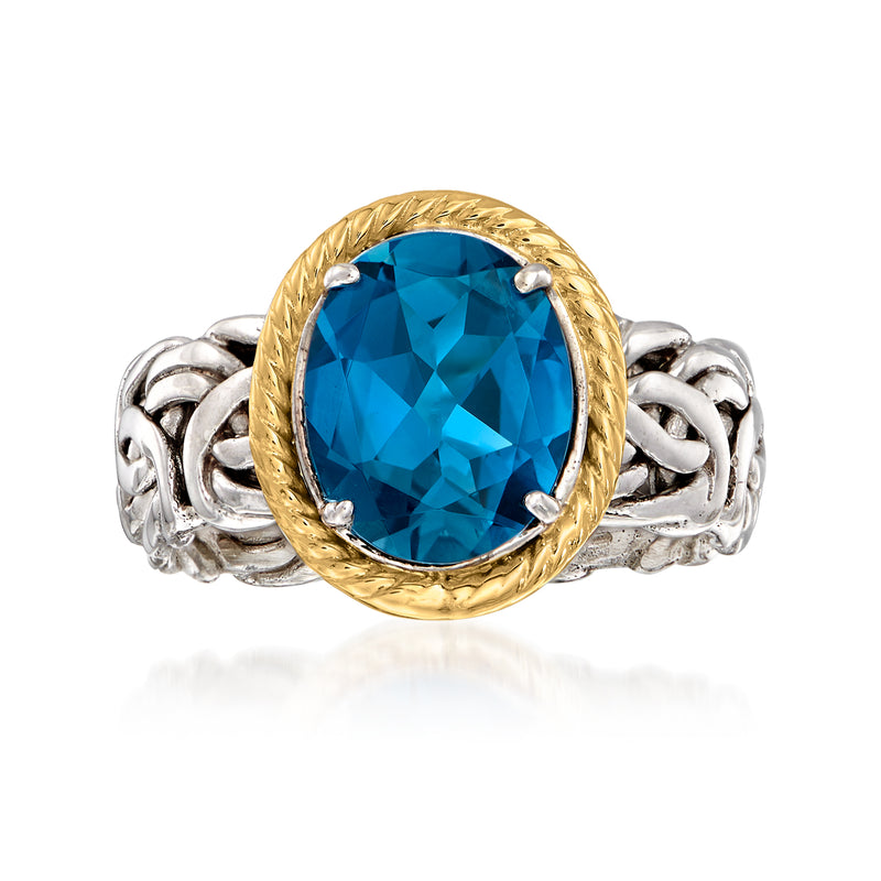 Oval blue topaz Byzantine ring with gold bezel, silver chain band, and side prongs