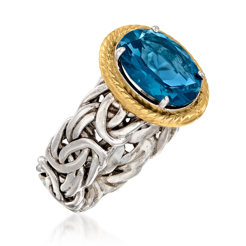Blue oval gemstone ring on twisted silver band with raised gold bezel; side view