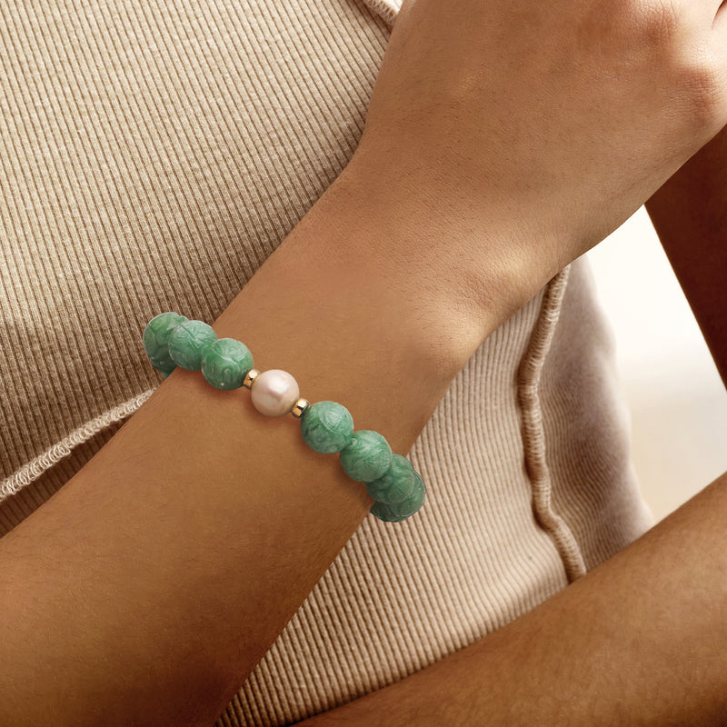 Bead stretch bracelet with green jade beads, white pearl center, and 14k yellow gold spacers
