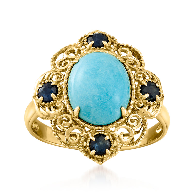 14kt yellow gold ring with oval turquoise cabochon and two dark blue sapphire stones