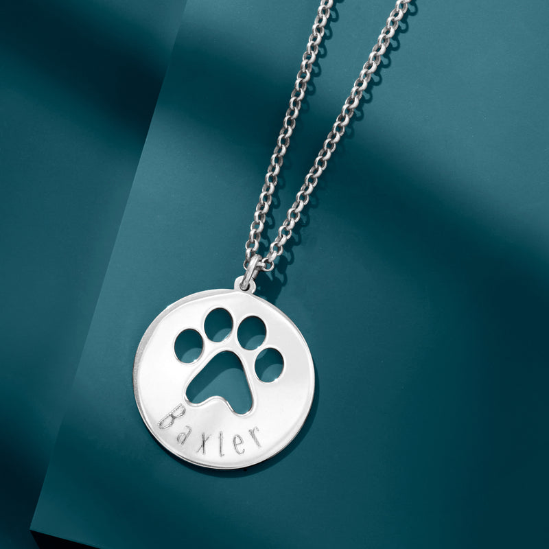 Sterling silver round paw print pendant on a chain with engraved Baxter