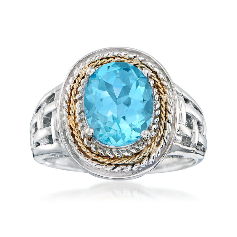Blue topaz oval ring with woven gold halo, sterling silver band