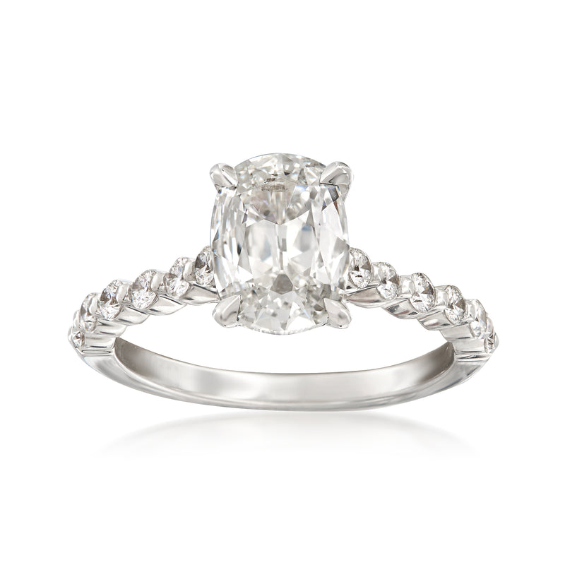 18kt white gold engagement ring with cushion-cut center diamond and side stones