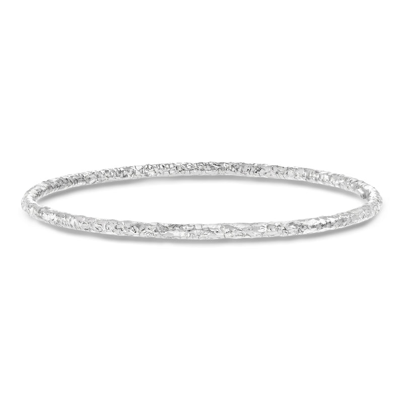 Hammered sterling silver bangle bracelet with textured surface and polished edges