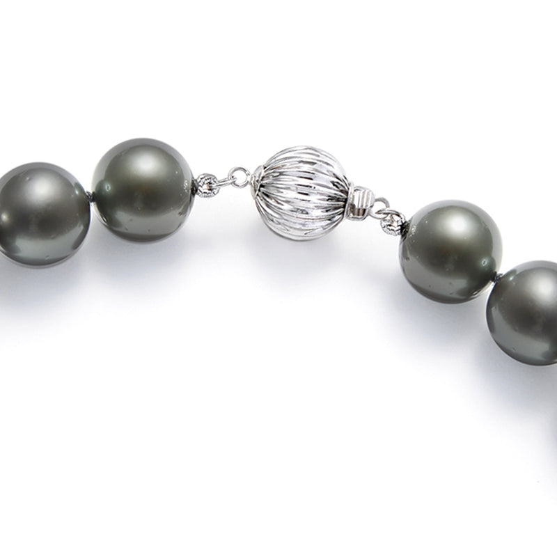 Close-up of 14kt white gold clasp with wire sphere between black pearls