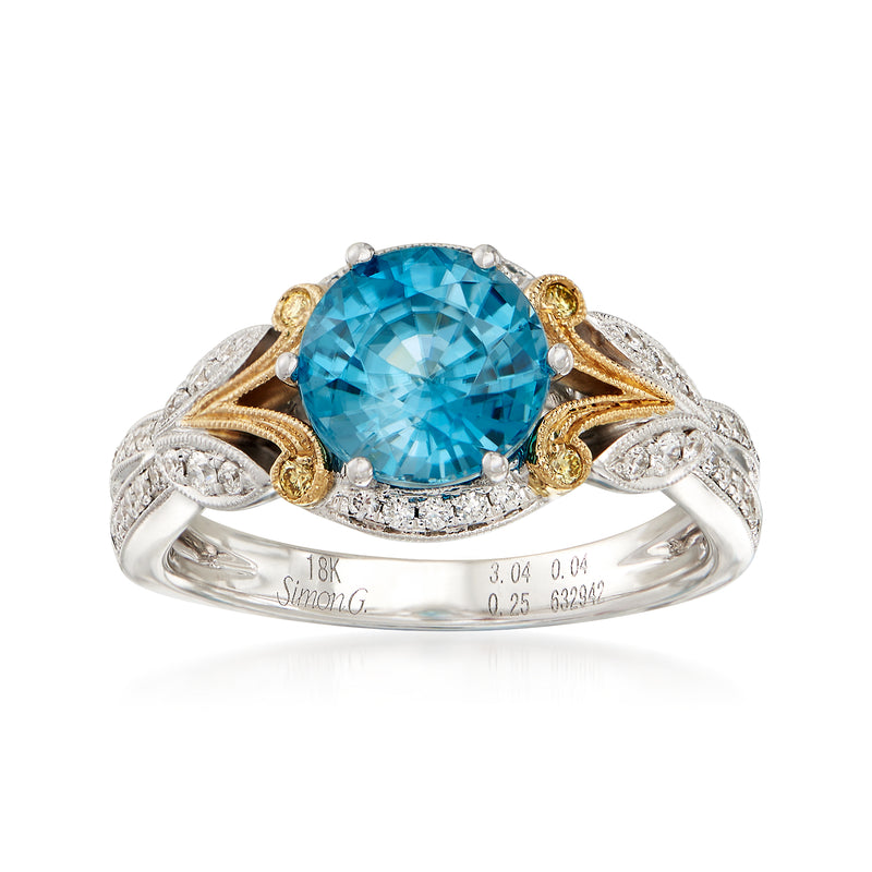 Two-tone 18k gold ring with large blue oval zircon center and diamond halo
