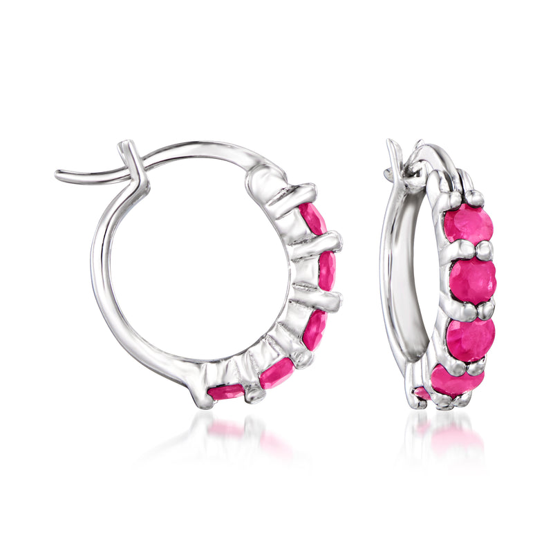 Sterling silver huggie hoop earrings with pink stone row, side view