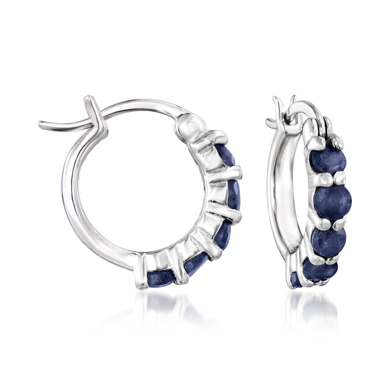 Sterling silver huggie hoop earrings with dark blue stone row, side view