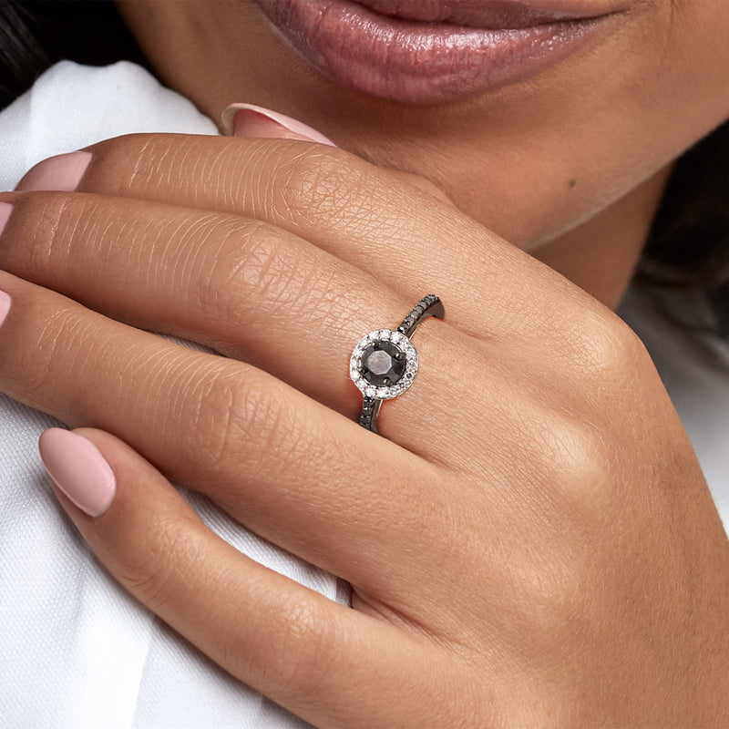 Sterling silver black and white diamond halo ring on hand