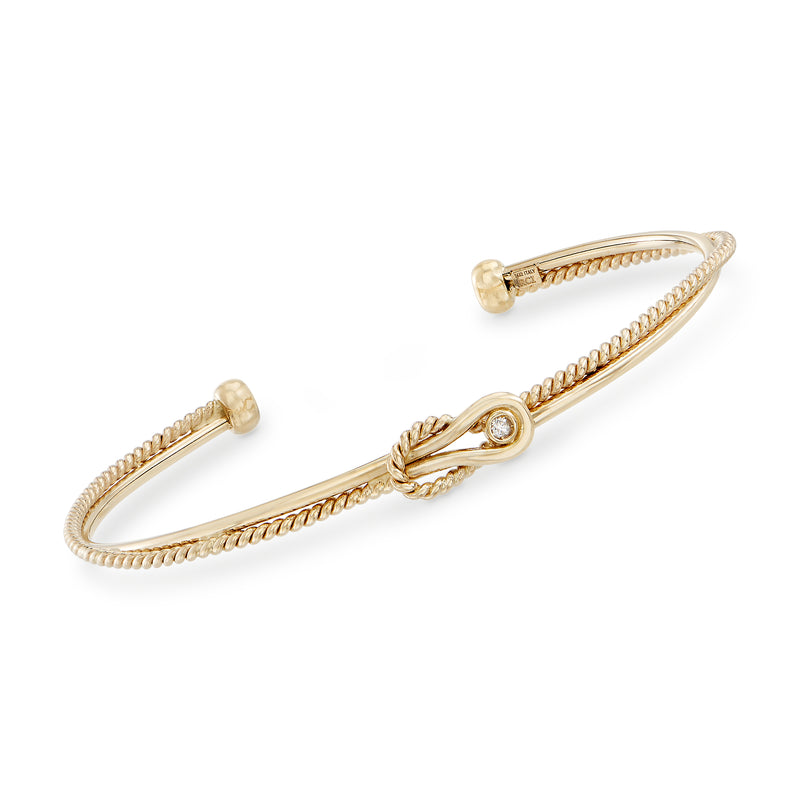 14kt yellow gold cuff bracelet with braided cable texture and small diamond-like accent