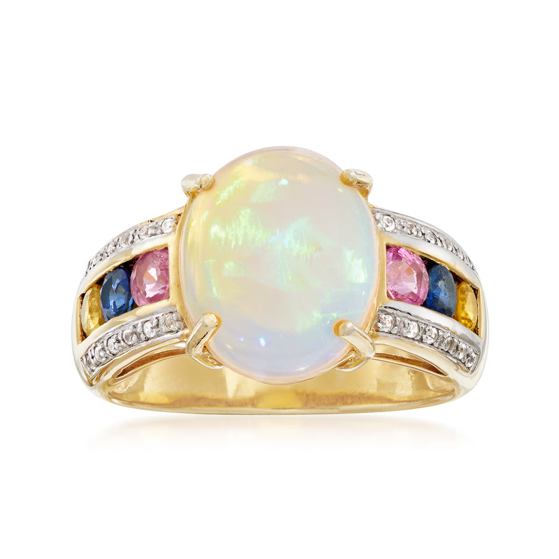 Opal center ring in yellow gold over silver, with blue, pink and clear side stones