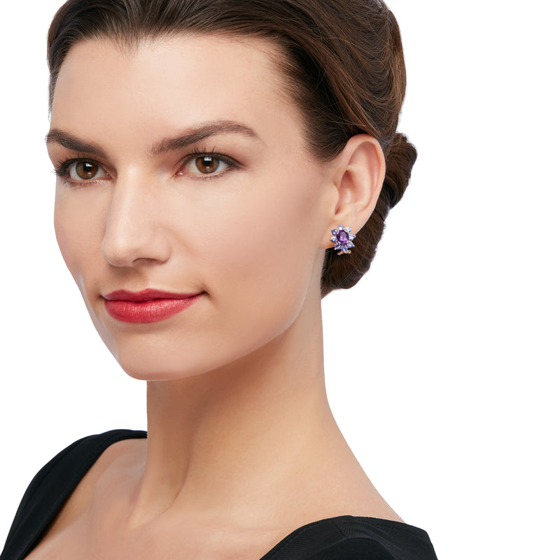 Sterling silver halo drop earrings on model, purple center with blue halo stones