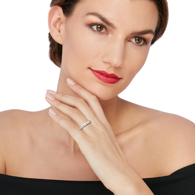 Diamond two-row ring in white gold with sparkling pave stones, worn on a hand