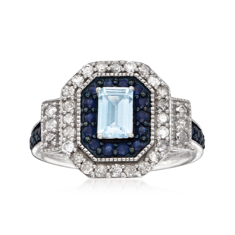 Sterling silver ring with aquamarine center, white halo, and dark blue stones