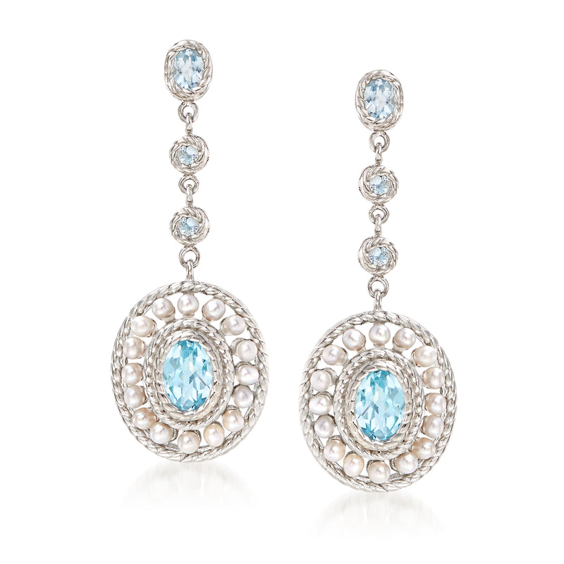 Sterling silver drop earrings with oval blue topaz and white pearl bezel dangles