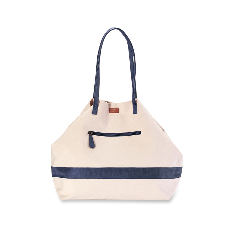 Expandable weekender tote with cream canvas body, navy handles, front zip pocket and trim