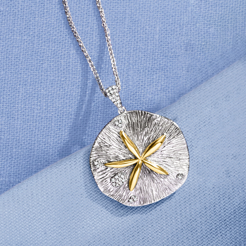 Sand dollar pendant close-up on sterling chain, yellow gold flower with small diamond details