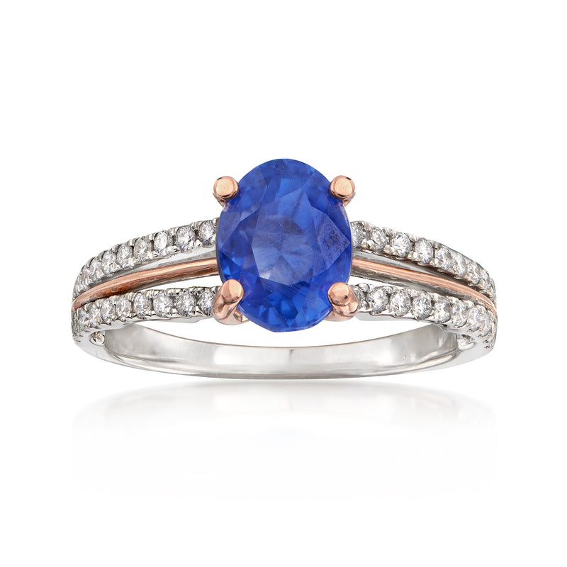 Two-tone gold ring with blue sapphire center and diamond pave accents