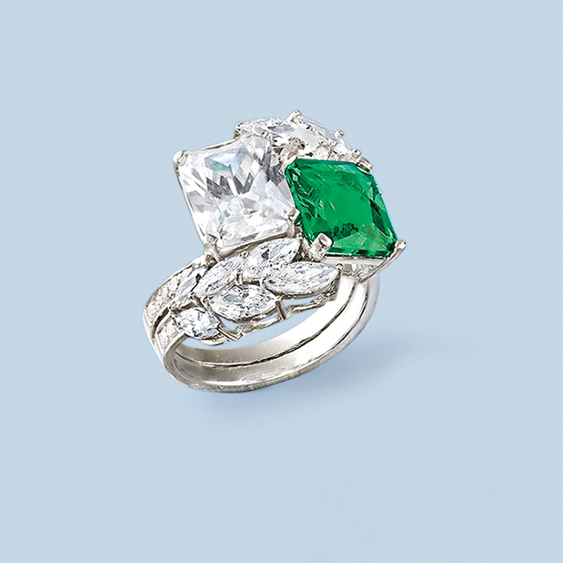 Sterling silver ring featuring green emerald-cut center stone with clear square stones