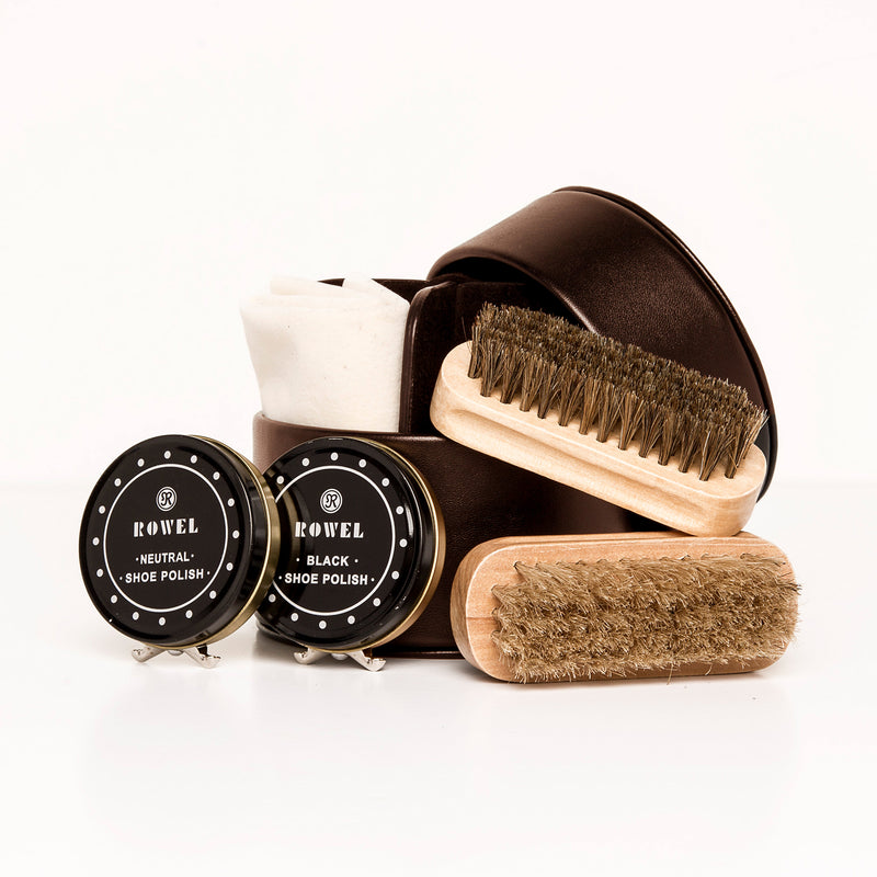 Shoe shine kit with round shoe polish tins and wooden brushes in a carrying case