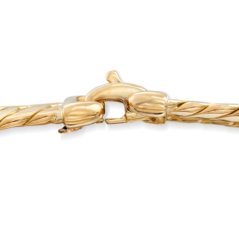 Polished Cuban-link bracelet clasp detail in 14kt yellow gold, interlocking links