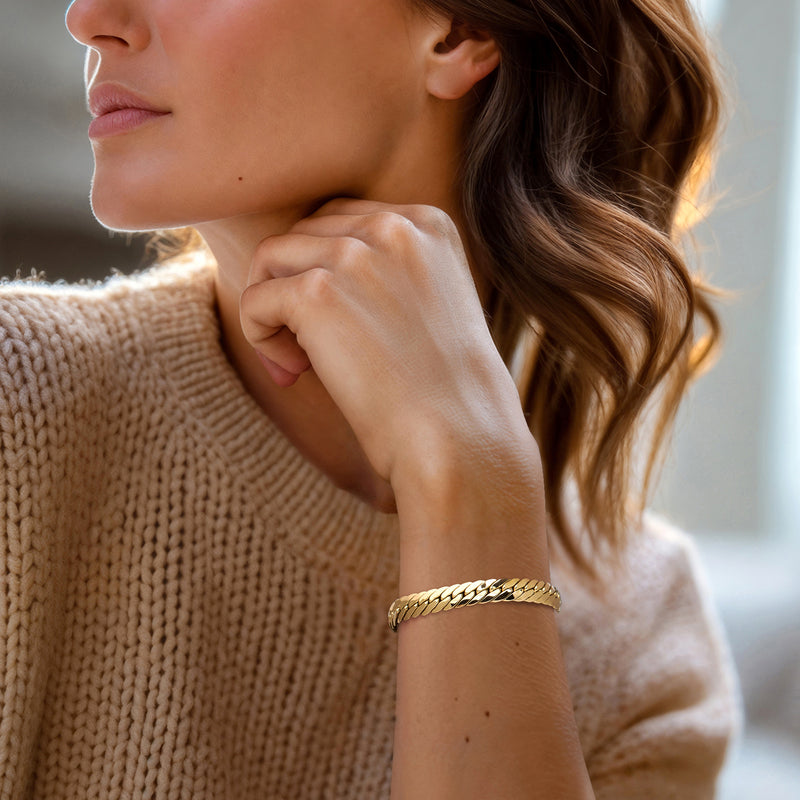 14kt yellow gold Cuban-link bracelet on wrist, polished chain with box clasp