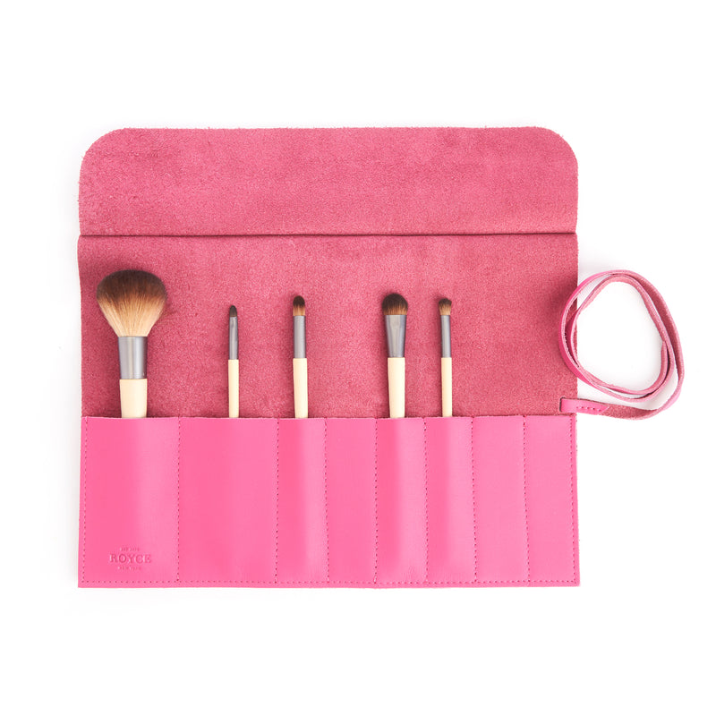 Pink leather makeup brush roll with six brush slots and tied strap