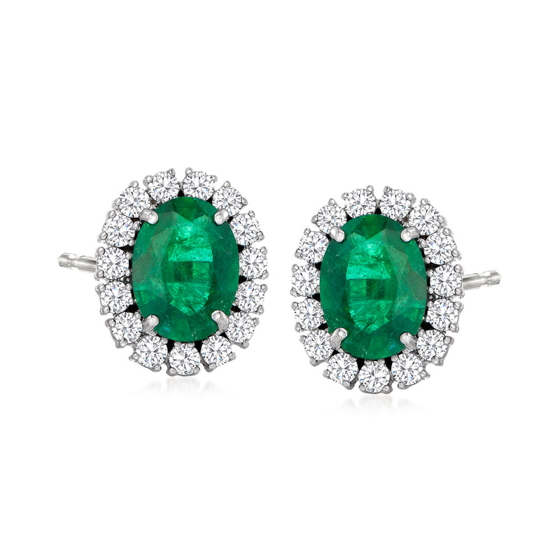 Emerald green oval stud earrings in 18k white gold with diamond halo