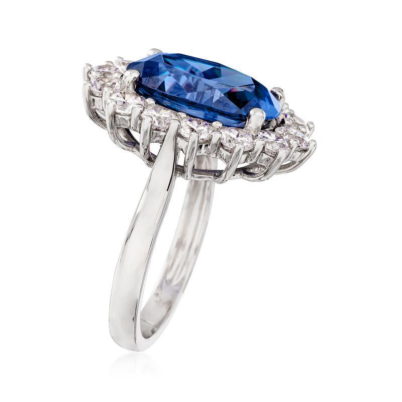 Sterling silver ring with oval blue center stone, side view with clear CZ halo