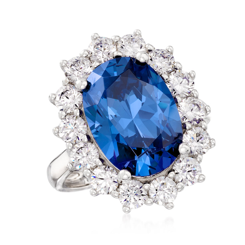 Sterling silver oval blue center stone ring with round clear CZ halo and prong setting