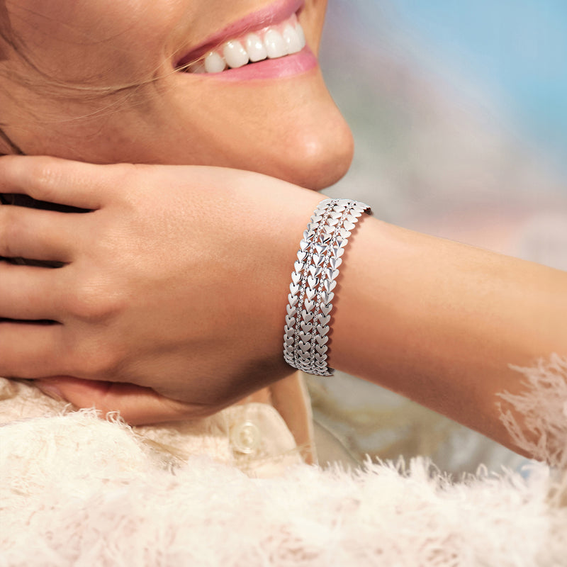 Sterling silver heart bracelet on wrist, multi-row linked hearts