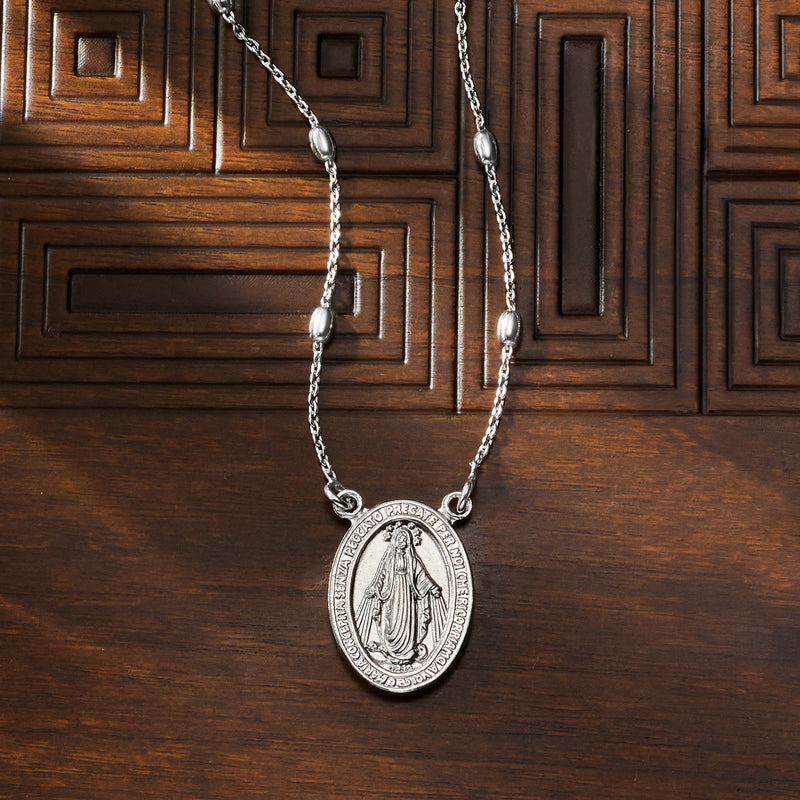 Miraculous medal station necklace in sterling silver with oval pendant on linked chain