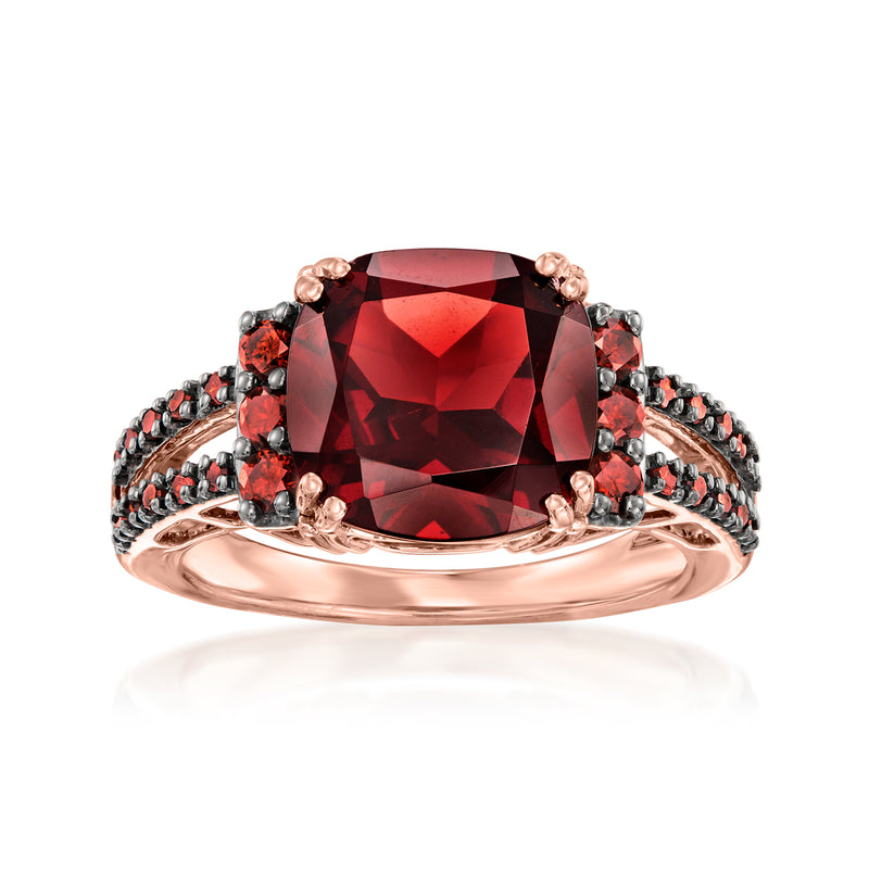 Rose gold ring with large red oval garnet and dark accented side stones