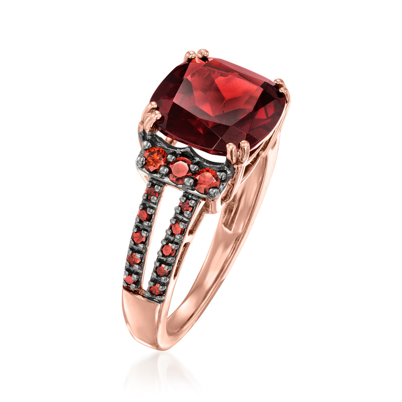 Rose gold ring with oversized red oval gemstone and dark halo-like side stones