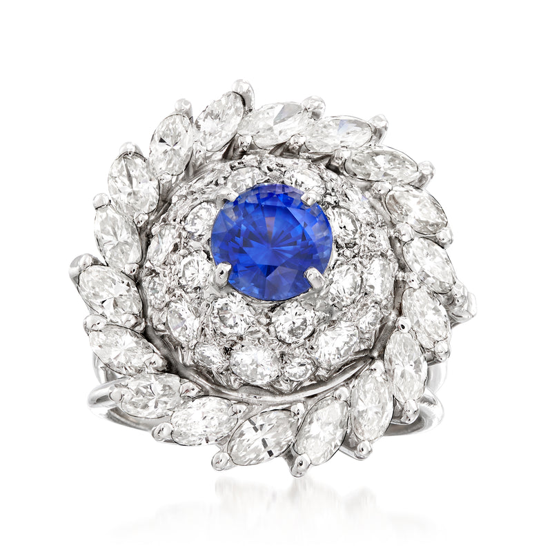Vintage white gold cluster ring with blue sapphire center and diamond halo