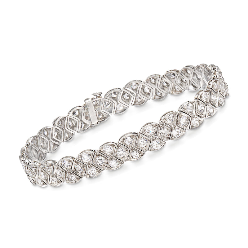 Vintage platinum diamond bracelet with repeating oval settings and hinged clasp