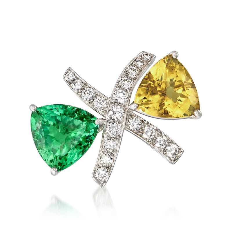 Gemstone cross pin with green and yellow stones, surrounded by diamond accents in white metal