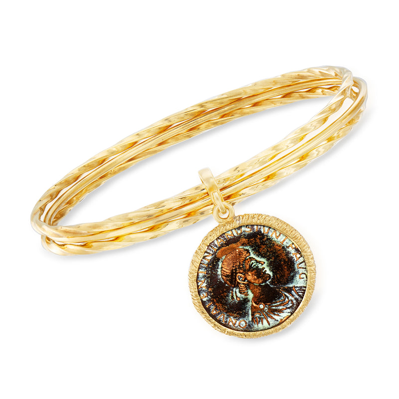 Gold-tone triple bangle bracelet with round bronze coin charm, hinged drop clasp