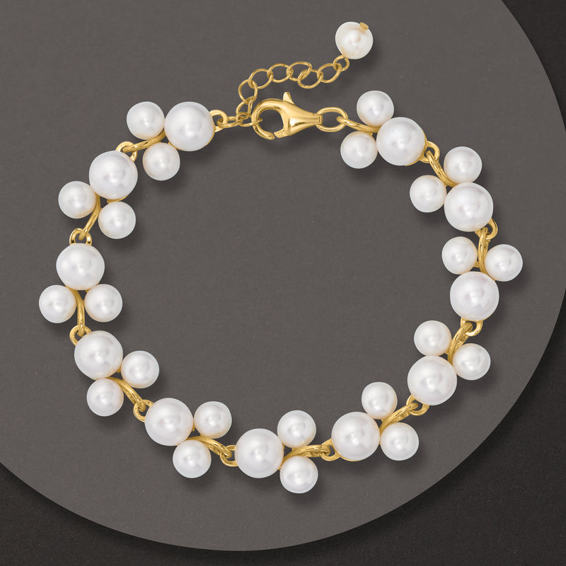 White pearl beaded bracelet with gold-tone chain and round links, round clasp closure.