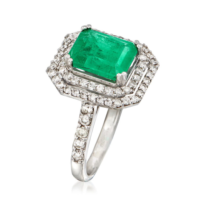 Emerald-cut green gemstone ring with diamond halo and white gold band