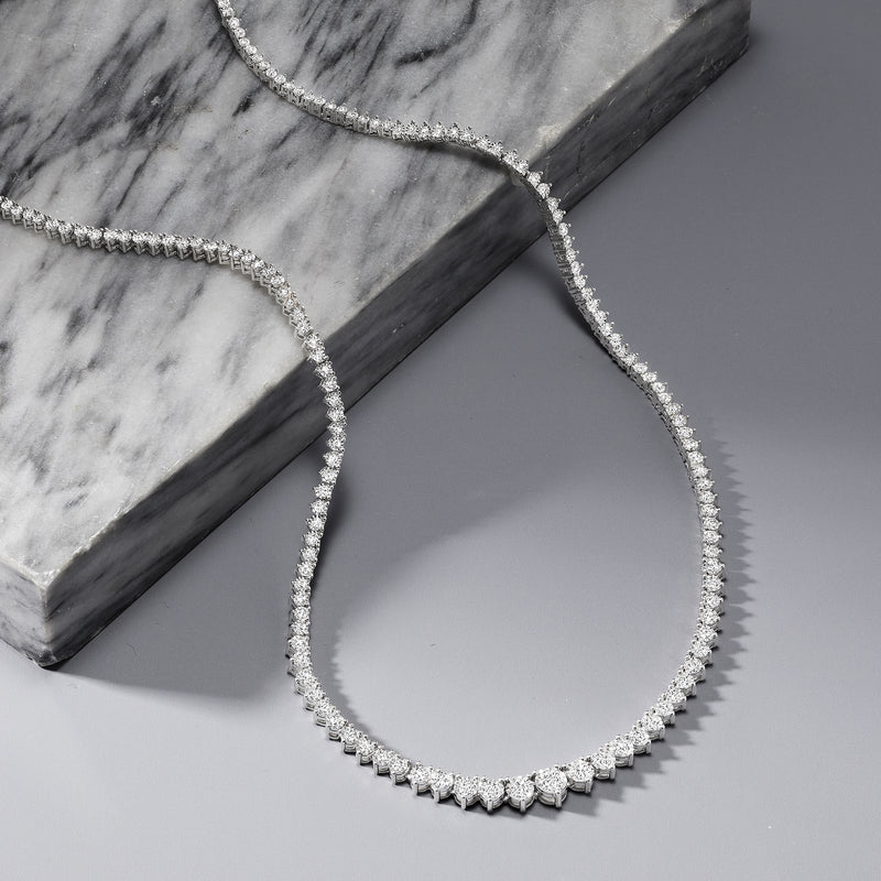 Close view of sterling silver diamond tennis necklace with small round stones on chain